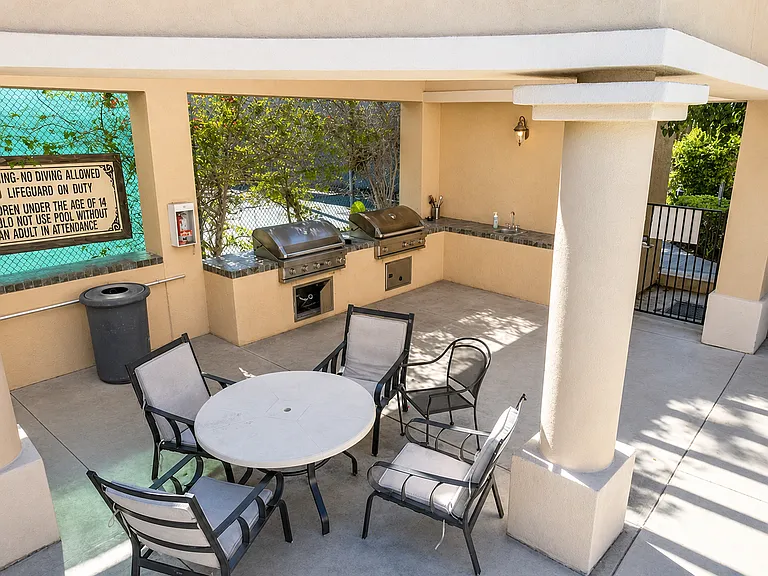 Barbecue and tennis courts facing the pool