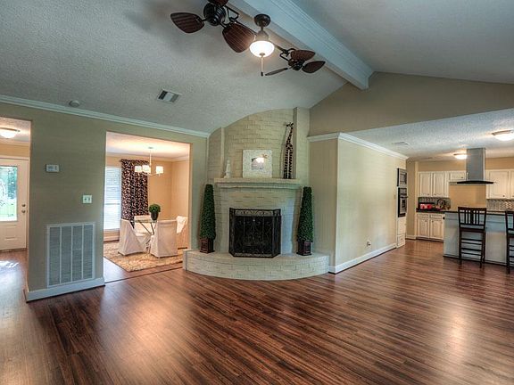 Enjoy this spacious living room featuring a gorgeous fireplace!