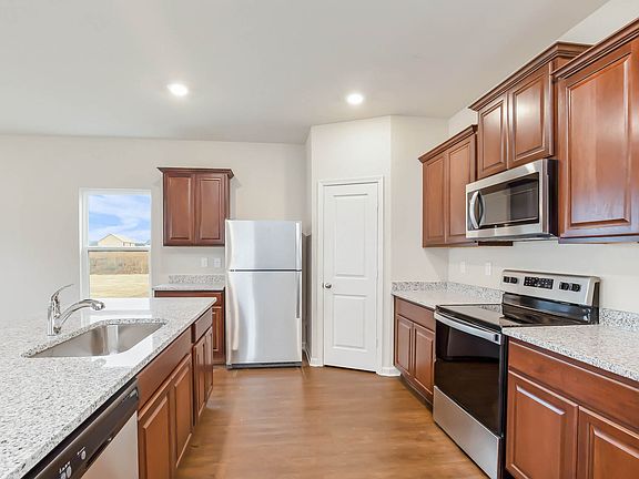 Gorgeous upper-wood cabinets with crown molding provide plenty of storage space