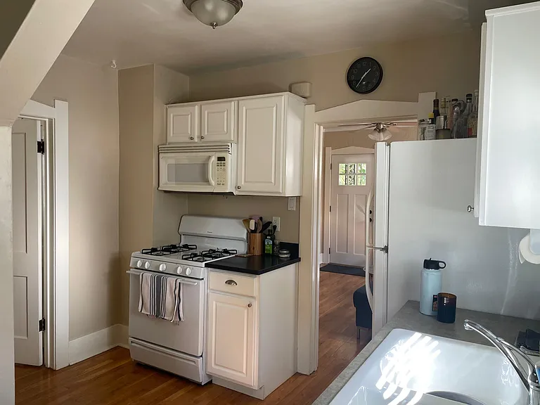 Kitchen looking at stove and microwave.