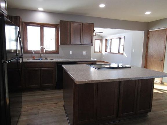 Another view of kitchen. Door to right is to garage and basement. Great room in distance.