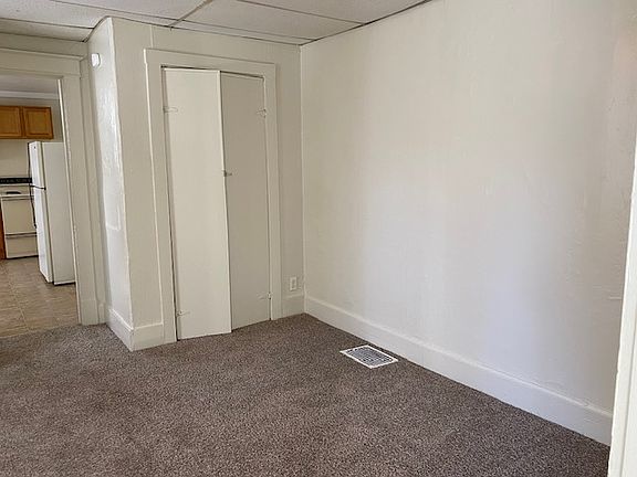 Right side of the living room/bedroom area and a second closet