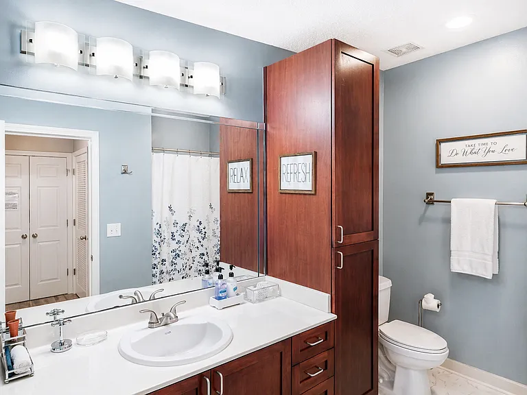 Enjoy a spacious bathroom with generous counter space, a soaking garden tub, and beautiful cherry wood cabinets.