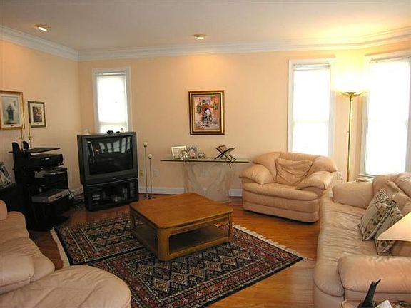 Separate living room is resplendent with natural light.