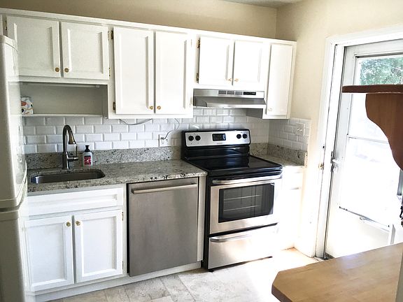 Light and bright kitchen with granite counters, stainless steel appliances and tons of work space.