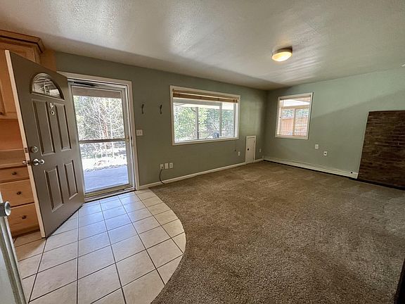 Inside patio entrance; living room and kitchen (partial view)