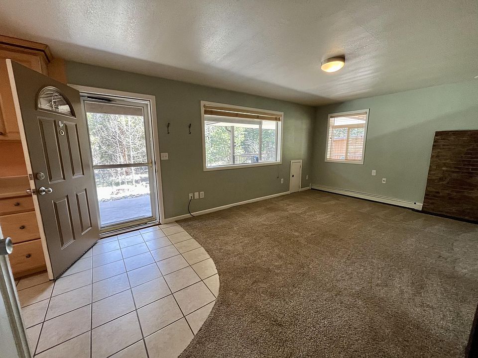 Inside patio entrance; living room and kitchen (partial view)