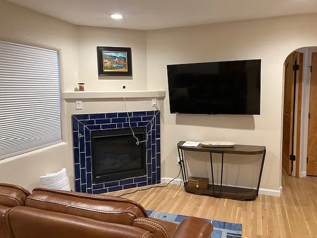Living room with reclining love seat and gas fire place with smart 55" TV
