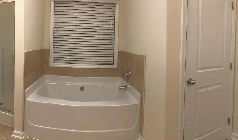 His and her vanities, separate shower booth, garden tub, and toilet