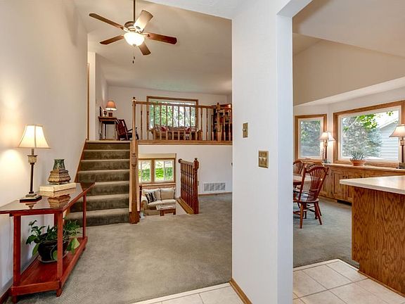 Front entry view of open floor plan with vaulted ceiling