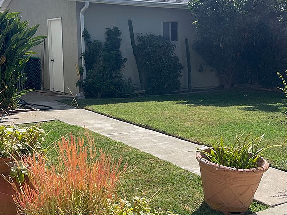 Back yard and patio with garage in back.