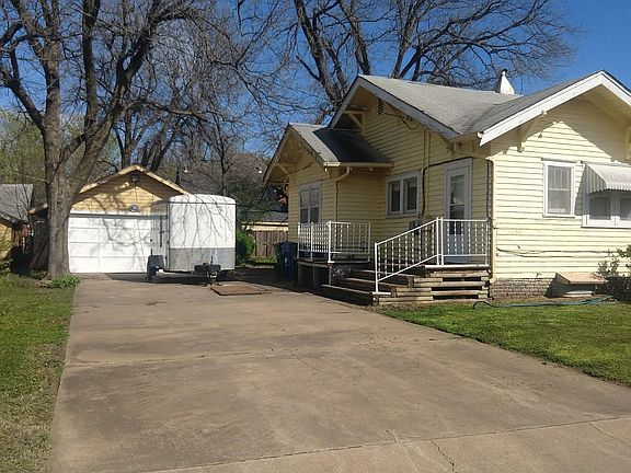 Two Car Garage with garage door opener. Long paved driveway.