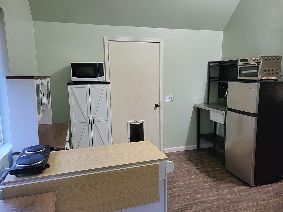 Kitchen with new microwave, convection oven, double hot plate, and refrigerator.