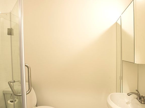 Bathroom with custom tile and glass enclosed shower