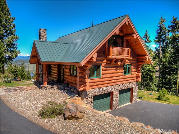 Backside of the house with double car garage. Private drive with full turn-about for ease of entry and exiting