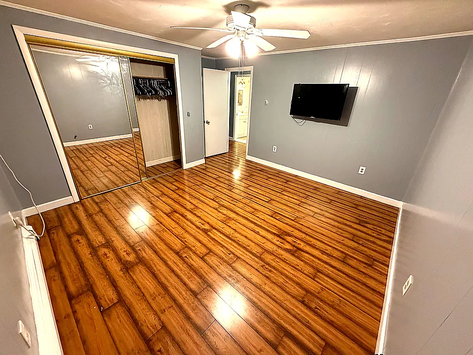 1st Bedroom with large closet and ceiling fan.