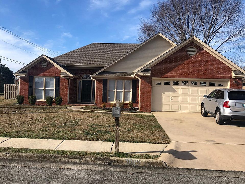 Front of house. Electric garage door with opener. Front door opens to foyer with vaulted ceiling_s in family room with fireplace/ gas logs.