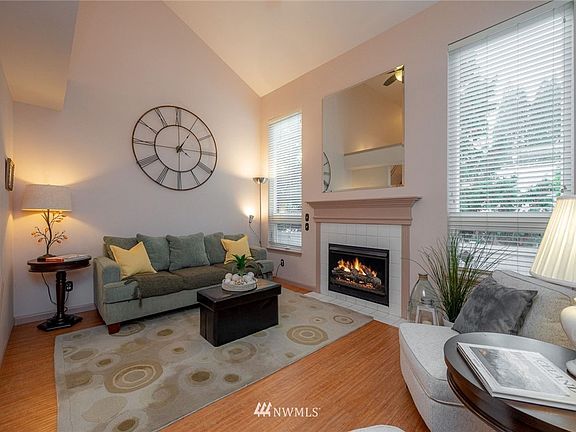 Vaulted ceilings and full height windows bath the living room with light and warmth.