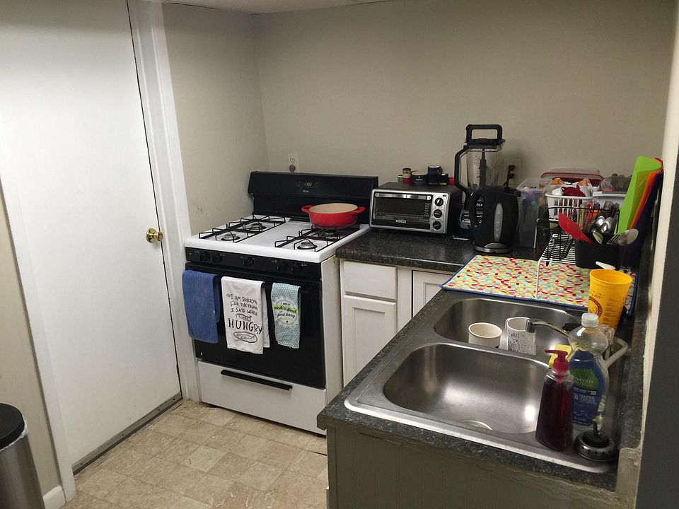 Kitchen, with door into the shared laundry room (2 other apartments enter the laundry from the back of the building). NOT coin operated.