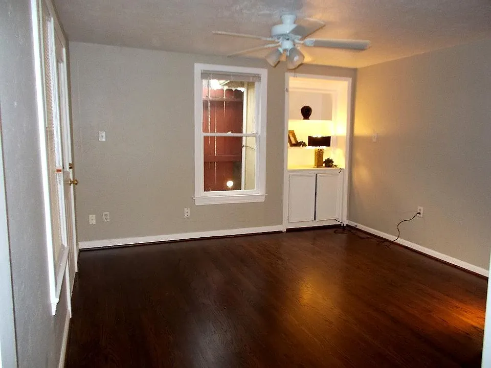 Living room with a small book shelf in corner.