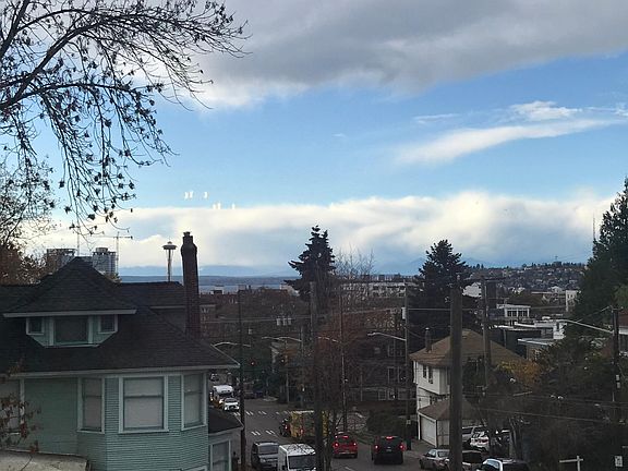 West facing living room window with view of Downtown, Space Needle, Puget Sound, and Olympic mountains