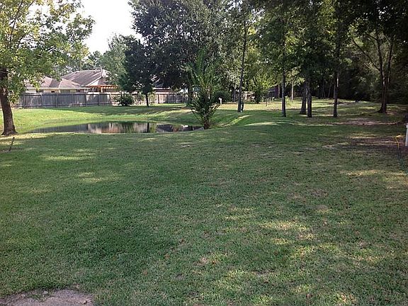 This view is from the entrance looking directly to the right. The property goes to a point in this direction (triangular-shaped property), with the tree line to the right, bordering Huffmeister Road.