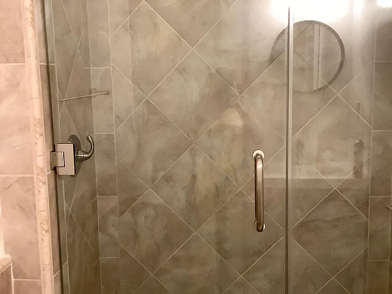SECOND BATHROOM HAS LARGE DESIGNER TILED SHOWER W/ GLASS SHOWER DOOR