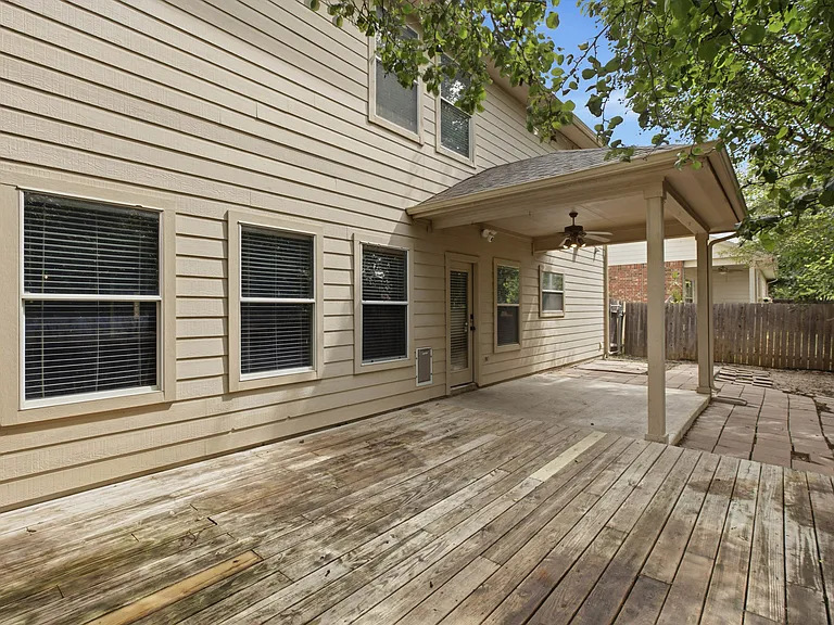 Large wooden deck, covered patio and large grassy section