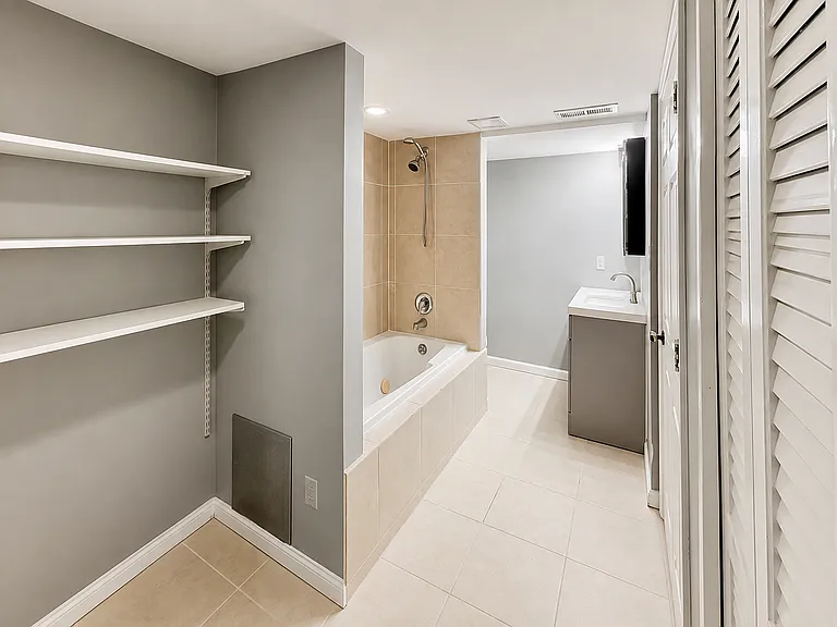 Wide bathroom view with storage/tub