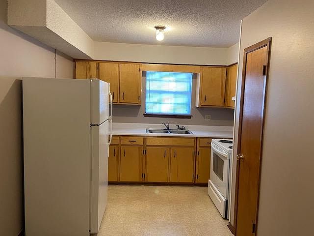 Kitchen with full size refrigerator and full size oven and pantry closet