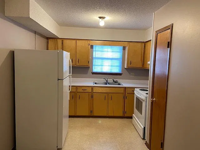 Kitchen with full size refrigerator and full size oven and pantry closet