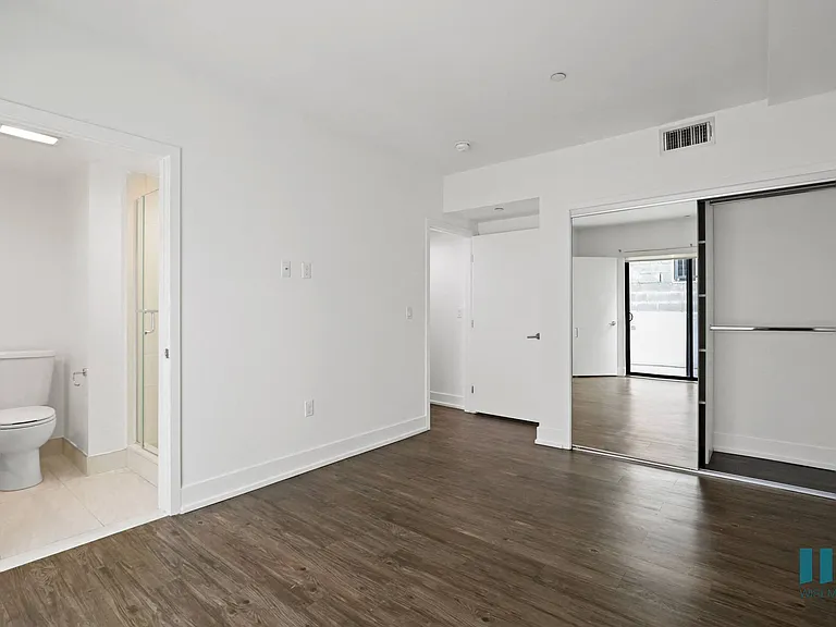 Bedroom with Mirrored Closet, Vinyl Flooring, Recessed Lighting, and Bathroom