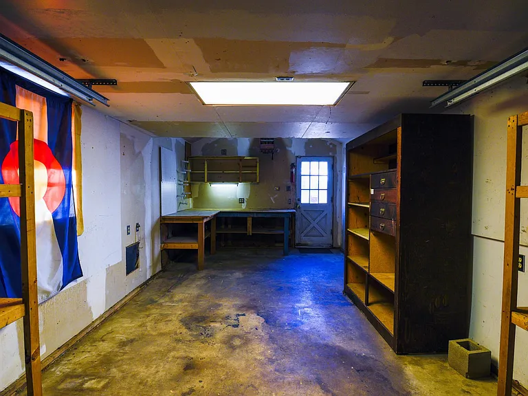 View from inside of back of garage with plenty of extra storage shelves.