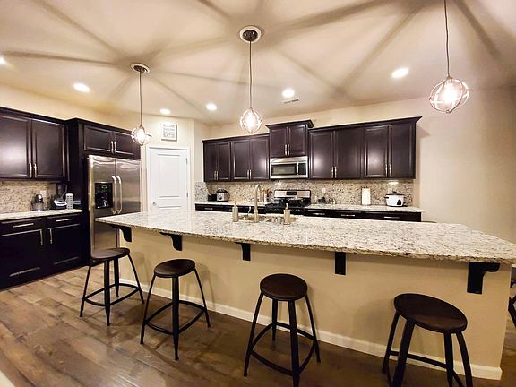Large Kitchen with 12 feet kitchen Island and blacksplash