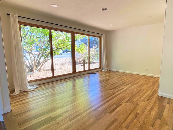Dining room with large windows and lots of natural light.