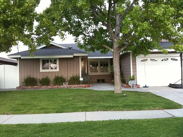 Front of the house. Two liquid amber trees provide shade without obscuring the light that that enters the home.