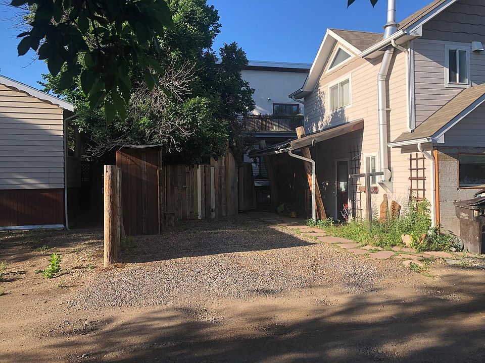 Carriage House, private parking, storage sheds, looking south to our main house through the gate