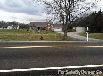 House Front
						:
						Bradford Pear tree and open front yard, privacy fence between shop and house.