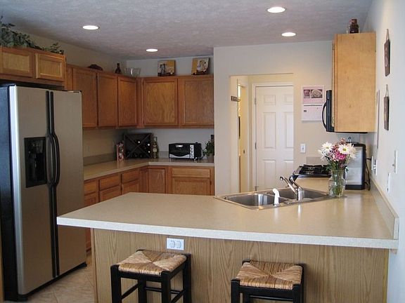 Spacious kitchen with stainless steel appliances and ceramic tile flooring