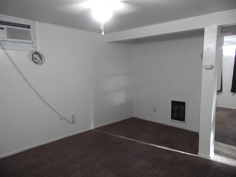 The apartment comes with AC, overhead light and ceiling fan. The open space allows you to arrange your furniture your way. A couch will fit comfortably in the space.