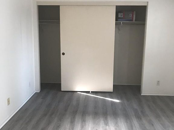 Bedroom with ceiling fan and new flooring
