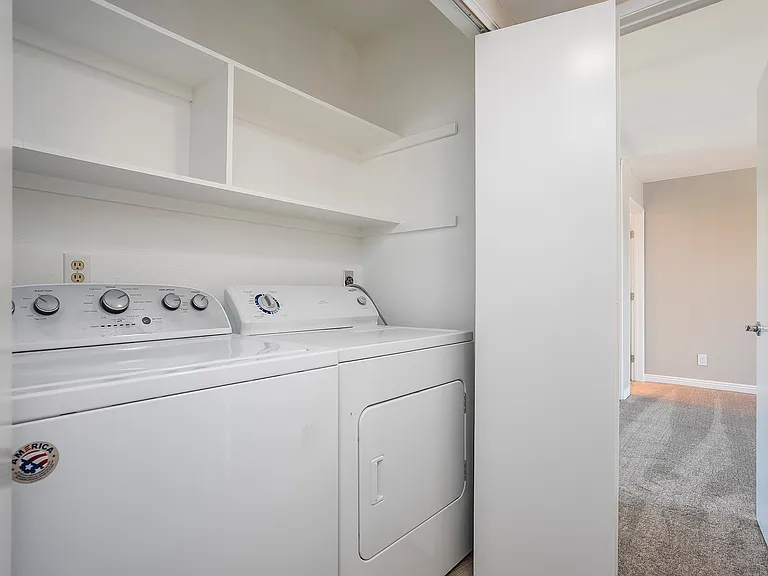 Laundry closet in the hallway, conveniently located just outside the primary bedroom.