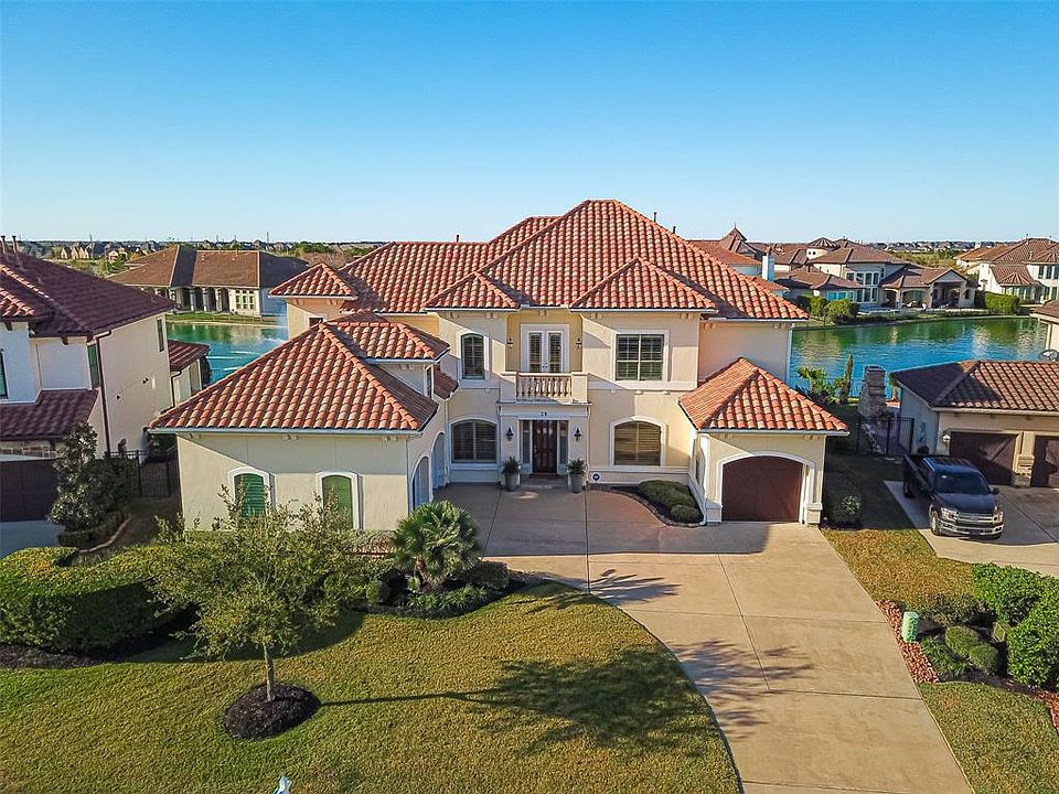 This stunning Kickerillo custom home is situated on a beautiful waterfront lot inside the gated Lakes of Cross Creek Ranch.
