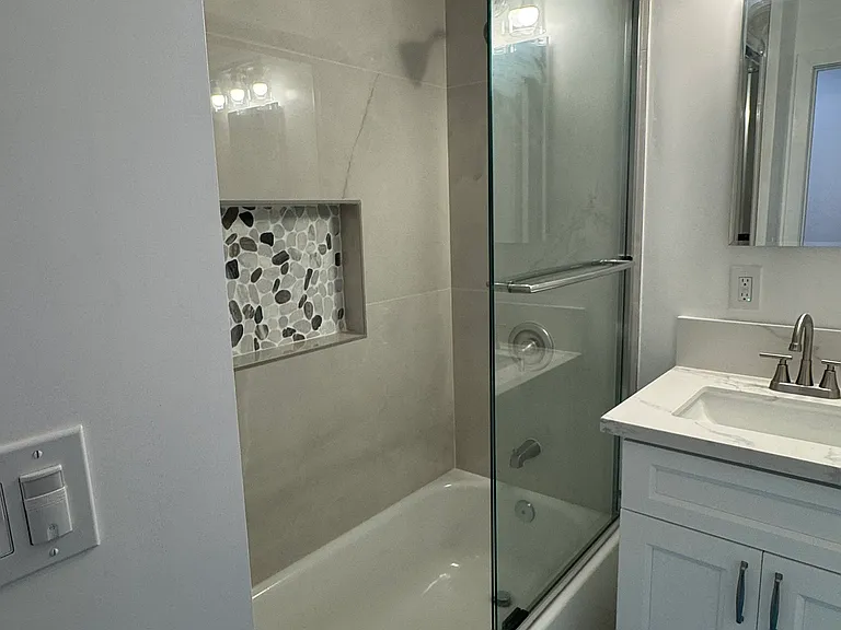 Secondary bath off hallway for convenient use with bathtub and shower.
