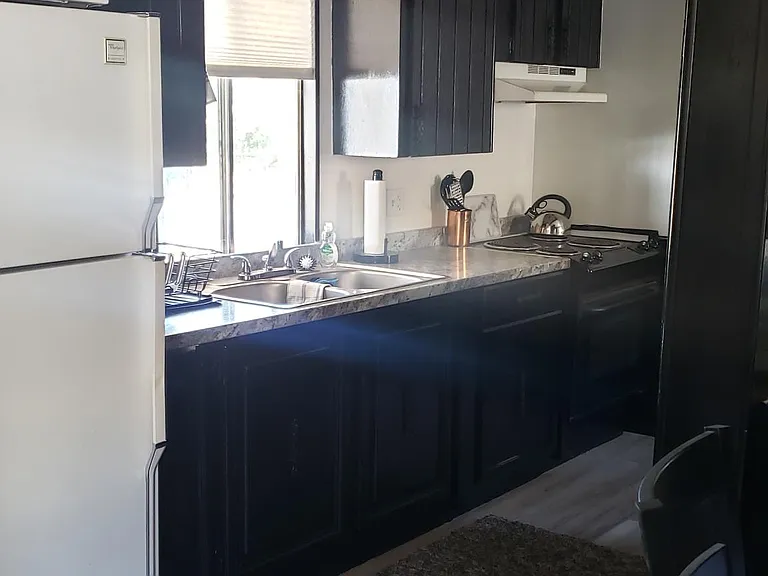 Kitchen with microwave, refrigerator, stove/oven and utensils