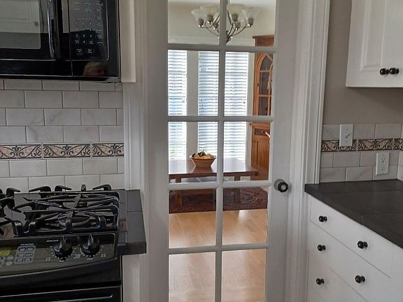 Lots of Kitchen cabinets with side pantry near side entry.
