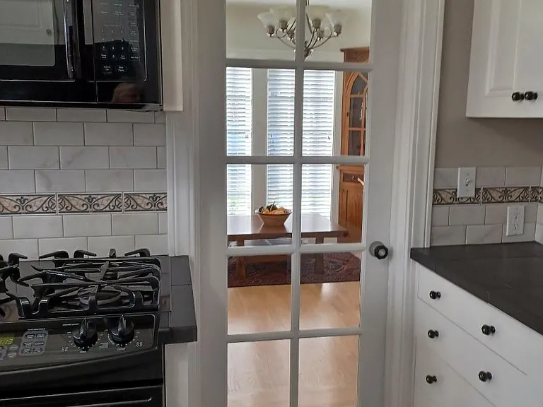 Lots of Kitchen cabinets with side pantry near side entry.