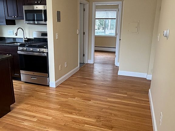 Livingroom kitchen area leads with bathroom and bedroom ahead