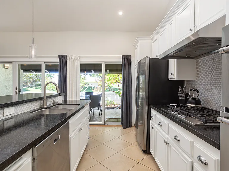 Galley Kitchen, with newer appliances, Correra tile, microwave, dishwasher and range with re-ingnite safety feature.