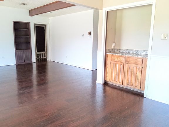 Built in bar in dining area and built in shelves in living room